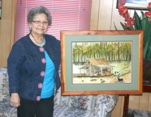 Holly Springs Baptist Church has been asked to send a mission team to help plant a church in Fort Walton Beach, Fla.  Team members are raising funds for this mission trip through church dinners on Wednesday night. A member, Gwen Chastain (pictured above), donated an original watercolor painting of a barn on Midway Road with an old A Model stored under a side shed. The barn is believed to be on Doug Thomas’ property. Michael Chastain is heading up the church plant in FWB and will be ordained the day after the team arrives. For more information on making a donation please call 898-3821. 