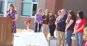 The Rev. Ashley McCoy-Bruce, left, speaks at a community service held in honor of Carly and Sawyer Simpson at Dacusville Elementary School last Thursday. 