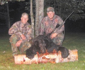 Roger Morsey, left, and Jeff Wright pose with a bear killed in 2009. 