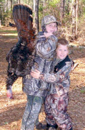 Author’s grandsons, Dylan and Ryan Cloer, with Dylan’s first wild turkey. 