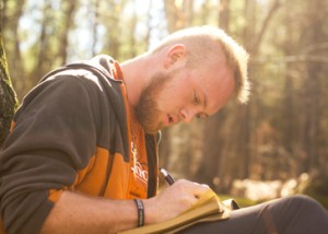 Jonathan Stegenga, a Southern Wesleyan University junior from northern Pickens County, jots down some thoughts in his notebook while spending time alone in a wooded area. This past fall, Southern Wesleyan University offered a new course devoted to the spiritual benefits gained from a solitary wilderness experience and a temporary retreat from an increasingly connected, urbanized society. 