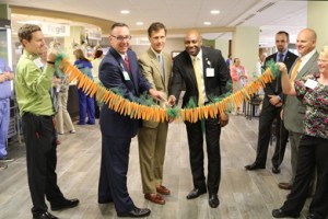 Baptist Easley and Unidine representatives cut a ribbon of carrots at the opening of Café 200.