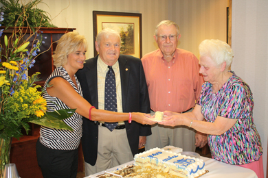 All Blue Ridge offices celebrated the cooperative’s 75th birthday with cake, punch and gifts for their members last week. Pictured are Blue Ridge’s Liza Holder serving cake to cooperative member Gertrude Hughes as Blue Ridge board members Jimmy Lee Dodgens and Frank Looper look on during the event at the Pickens office.