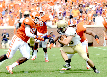 Kerry Gilstrap/Courier Clemson defenders, including former Daniel High standout Shaq Lawson, left, surround a Wofford ballcarrier during the Tigers’ win on Saturday.