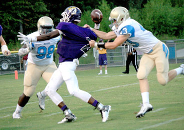 Rocky Nimmons/Courier Daniel defensive linemen Avery Conrad, right, and Miles Turmon combine to sack Emerald quarterback Meldrecous Jones during the Vikings’ win over the Lions on Friday night in Greenwood.