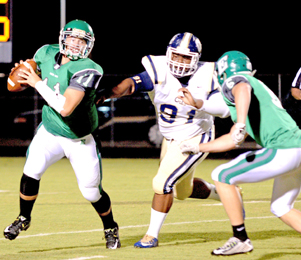 Kerry Gilstrap/Courier Easley quarterback Dalton Black scrambles away from pressure during the Green Wave’s home loss to Seneca on Friday night.