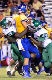 Tommy McGaha/Courier Easley’s Craig Barksdale, left, and Ivan Hill combine to bring down Wren quarterback Jay Urich during their game Friday night in Piedmont. 