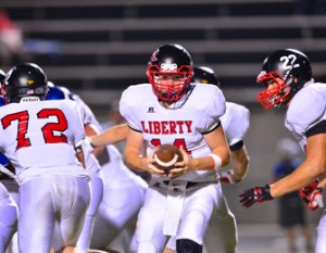 John Bolton/BoltonPhoto.com Liberty quarterback Austin Hughey, seen here preparing to hand the ball off to Tyler Renaud during the Devils’ game against Pickens earlier this month, will look to lead the Red Devils to a win at home over Landrum this Friday after last week’s loss at Powdersville.