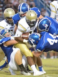 Tommy McGaha/Courier A swarm of Pickens defenders take down a Pendleton runner during the Bulldogs’ 26-16 win in the Blue Flame’s home opener on Friday night.