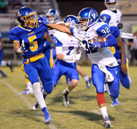 Tommy McGaha/Courier Pickens’ Adam Thomas stiff-arms Wren’s Trey McGowens during their game Friday night.a