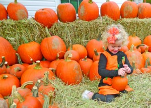 Thousands flock to Pumpkintown for the town’s annual early-fall Pumpkin Festival, enjoying fall weather and beautiful arts, crafts, music and food. Above, Kinsley Simmons, daughter of Pumpkintown resident Stacey Simmons, plays with a pumpkin during a past festival.