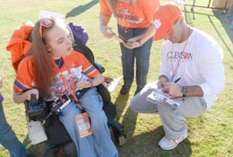 Courtesy Photo Clemson football coach Dabo Swinney signs an autograph for Kathryn Hicks, left, and her mother, Karen, at the Tigers’ practice in Clemson on Dec. 15.