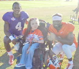 Courtesy Photo Six Mile resident Kathryn Hicks has her picture taken with Clemson star quarterback Deshaun Watson, left, and wide receiver Trevion Thompson following practice on Dec. 15.